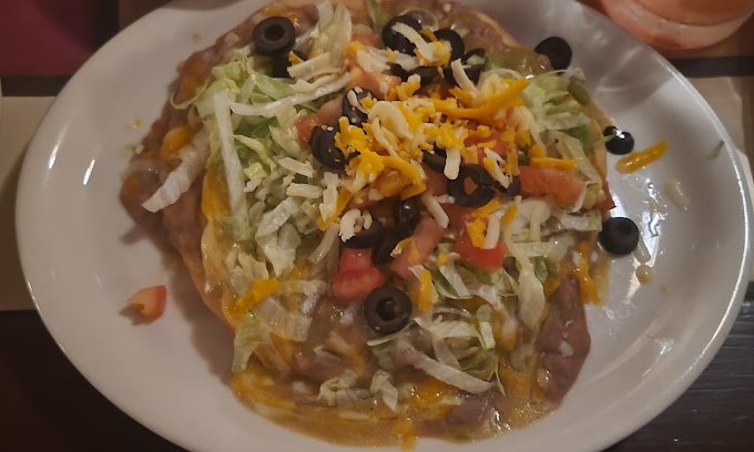 Tostada with lettuce, cheese and olives